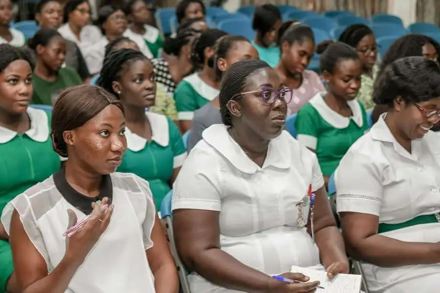 Group of newly trained nurses and midwives using computers to access their PIN codes on the NSA website for the 2025/2026 national service registration.